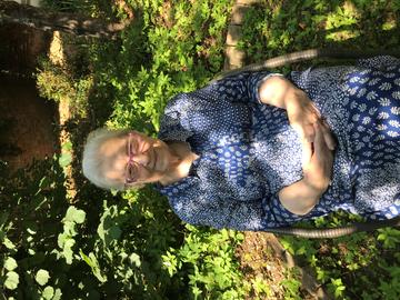 Lidia sciama lidia sciama - an older woman sitting in a sunny garden